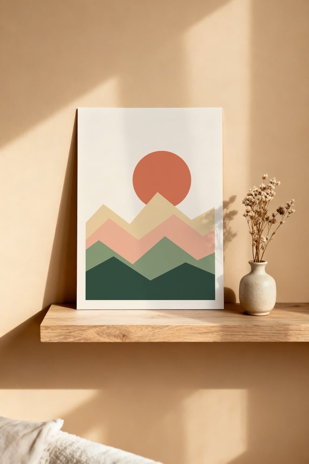 Sample wall art mockup: a sun and mountains print leaning on a wooden shelf next to a vase